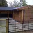 Stables with shoeing/washdown area with shingle roof image #1
